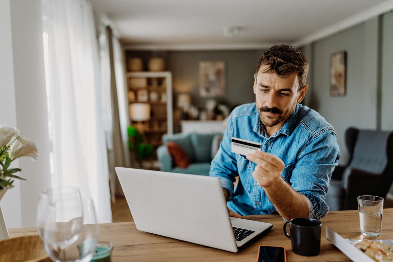 I want to pay off $20,000 of credit-card debt in one year. Should I hire someone to negotiate my bill?